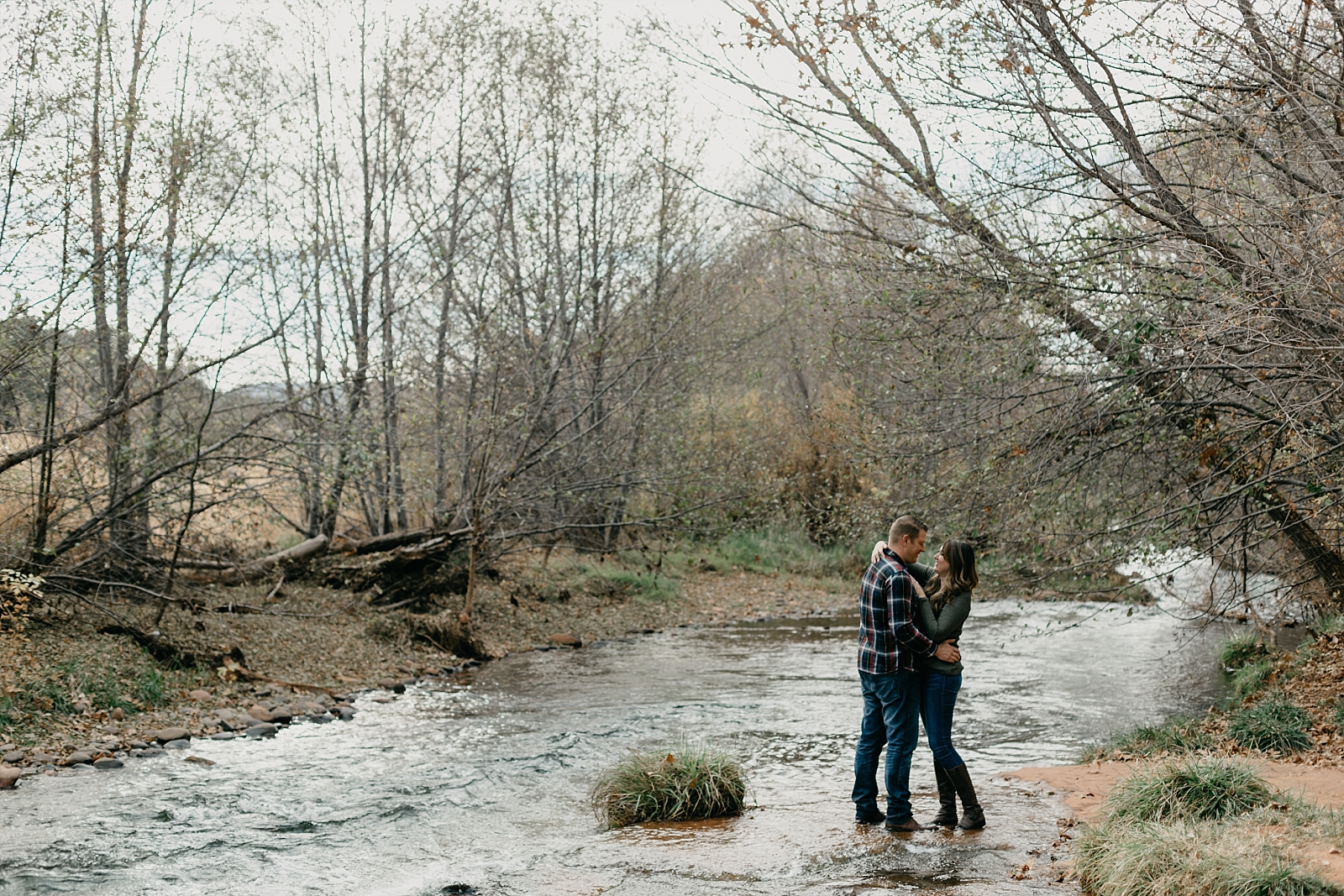 Couple in the water adventurous Sedona engagement photos Red Rock Crossing Crescent Moon Ranch Samantha Patri Photography