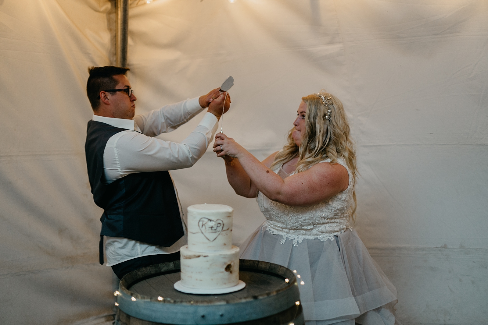 Cake cutting sword fight outdoor backyard tent fun Wedding Photos Prescott, Arizona Samantha Patri Photography