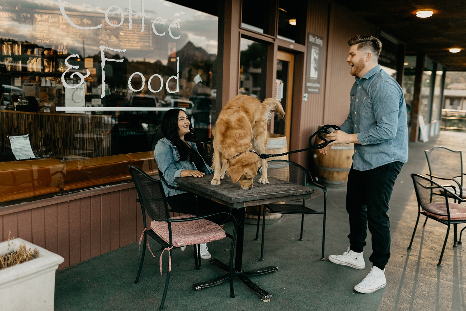 Coffee shop window with a view downtown sedona engagement photos with a pet dog Northern AZ Samantha Patri Photography
