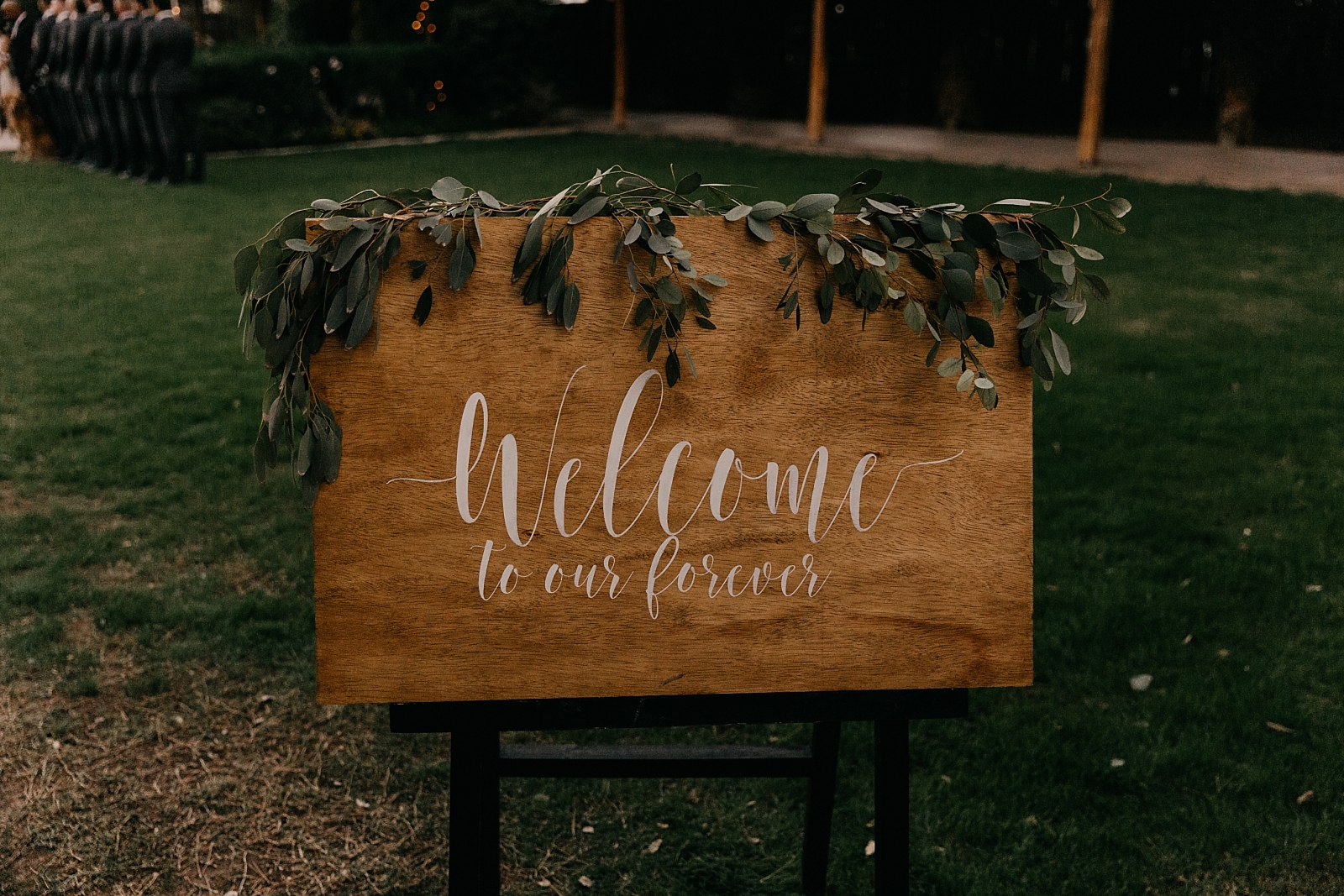 rustic modern green ceremony setup details welcome to our forever wooden sign with eucalyptus Shenandoah Mill wedding photographer Gilbert AZ Arizona Samantha Patri Photography