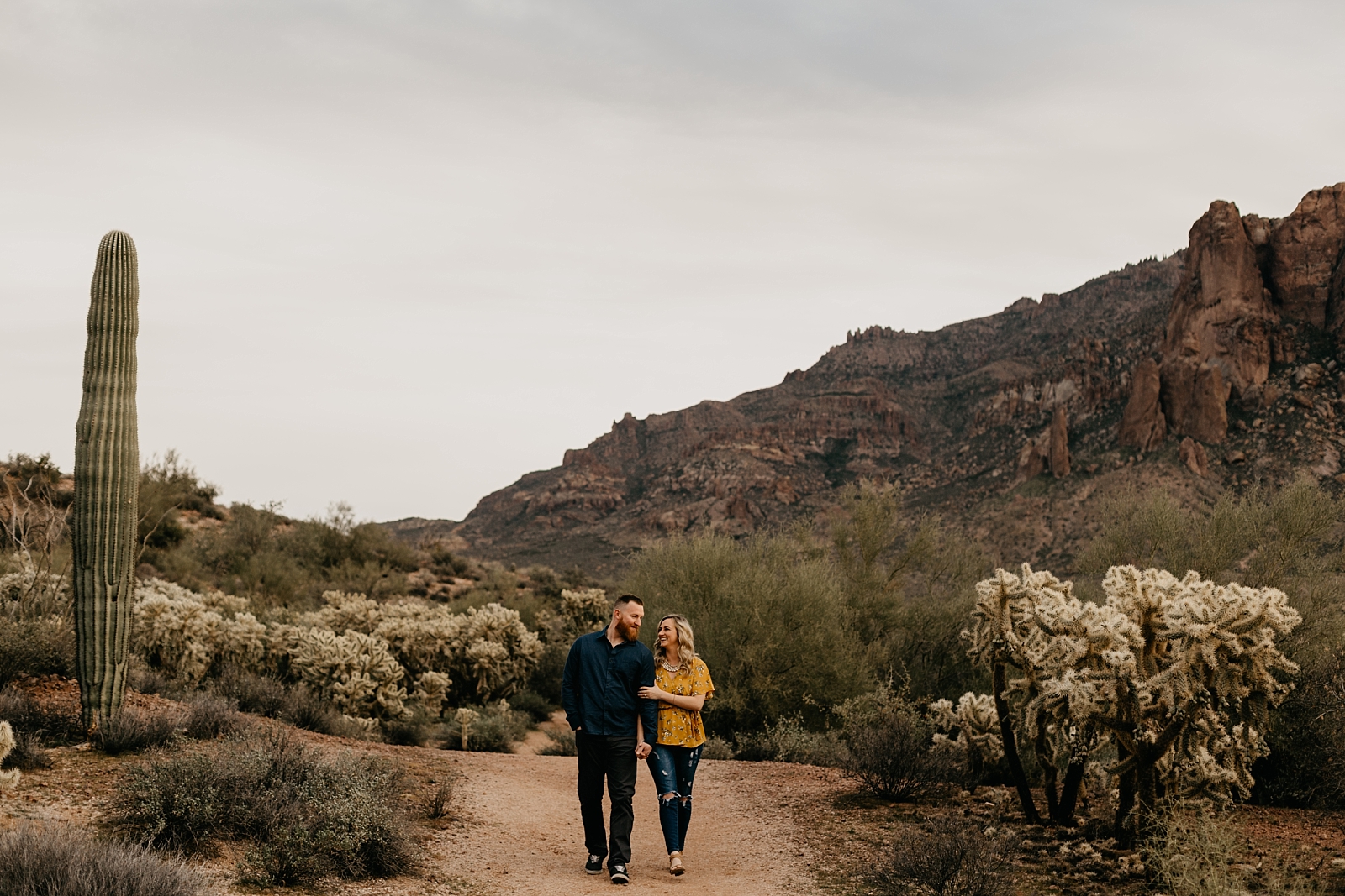 silly couple laughing walking Lost Dutchman Superstition Mountains engagement photo in the desert Phoenix, AZ Samantha Patri Photography