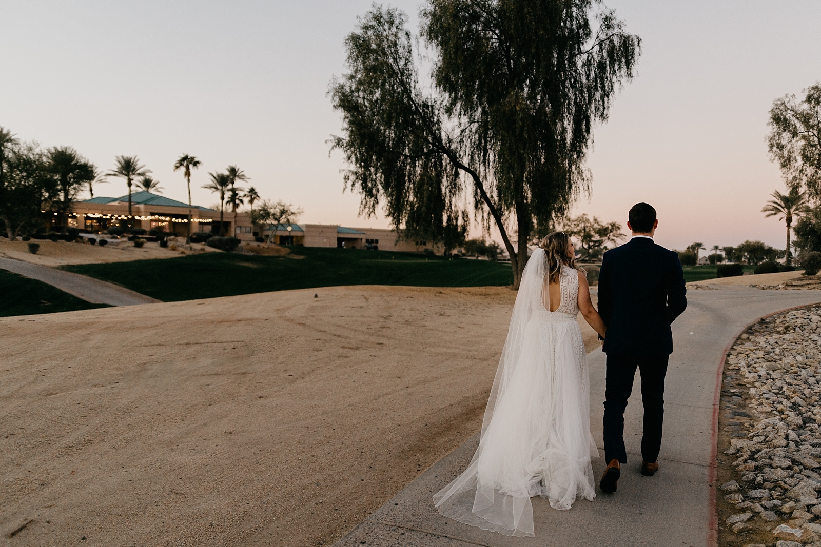 Bride and groom walking Palm Valley by Wedgewood Wedding photo in Goodyear, AZ