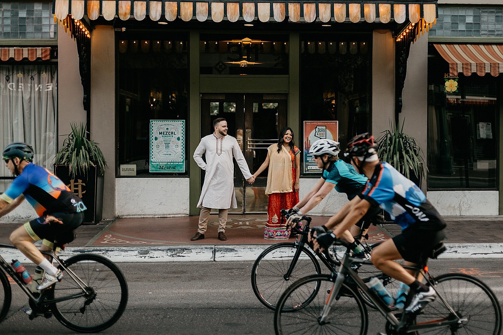 downtown tucson engagement photo hotel congress bikes passing on the street