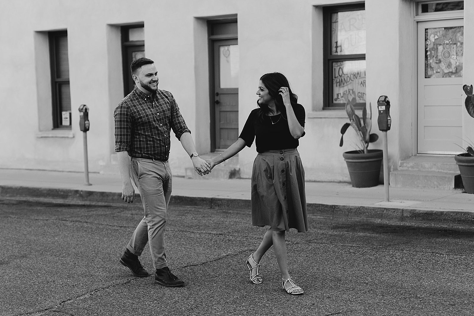 Downtown Tucson arizona engagement photos couple walking in street black and white