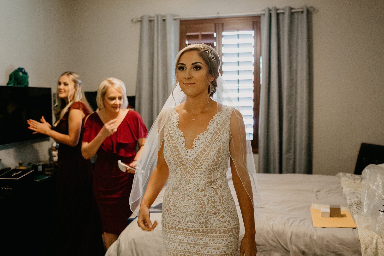 Bride getting ready in her parent's bedroom for their backyard elopement