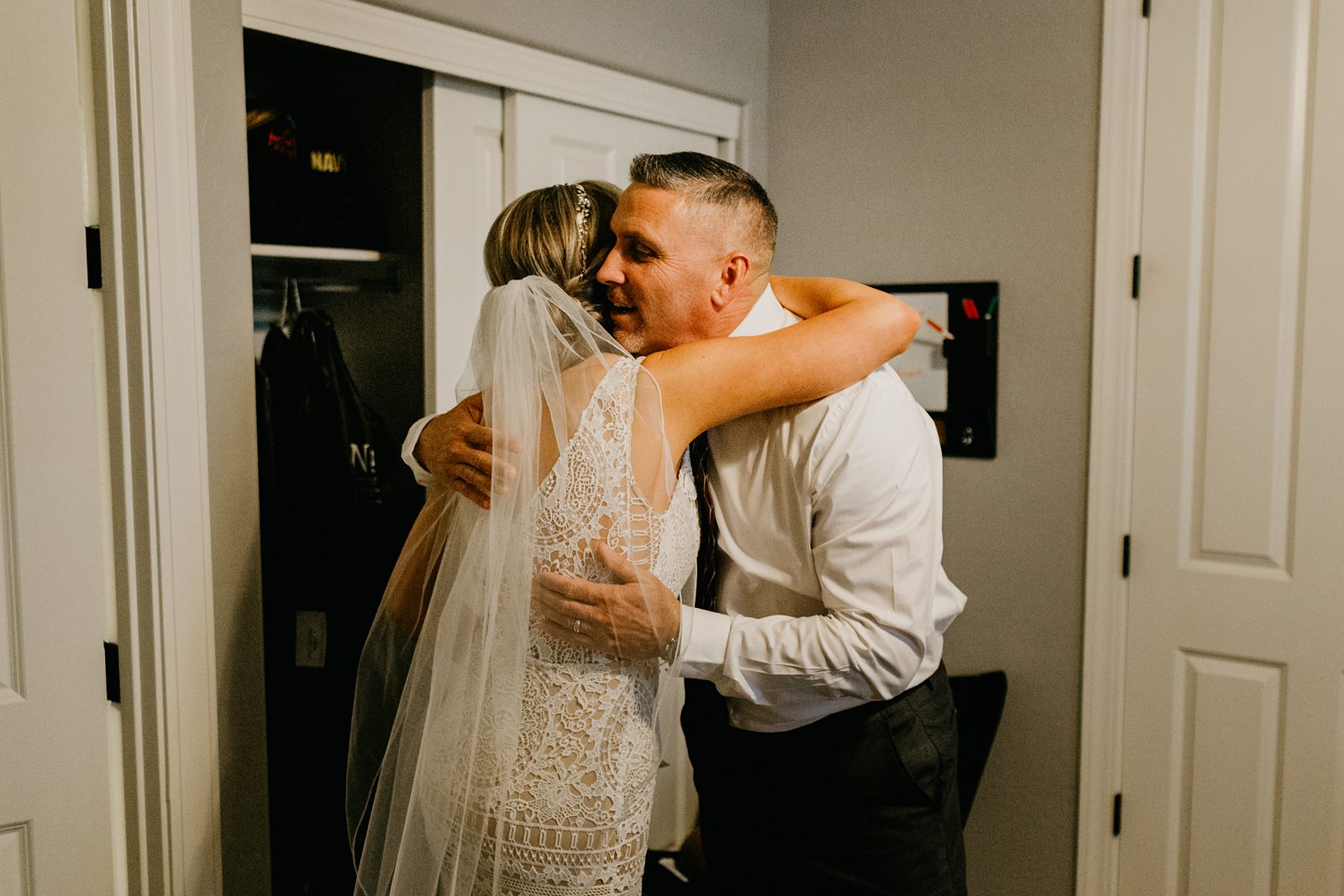 Bride's dad hugging her after seeing her for the first time on her wedding day for her backyard elopement