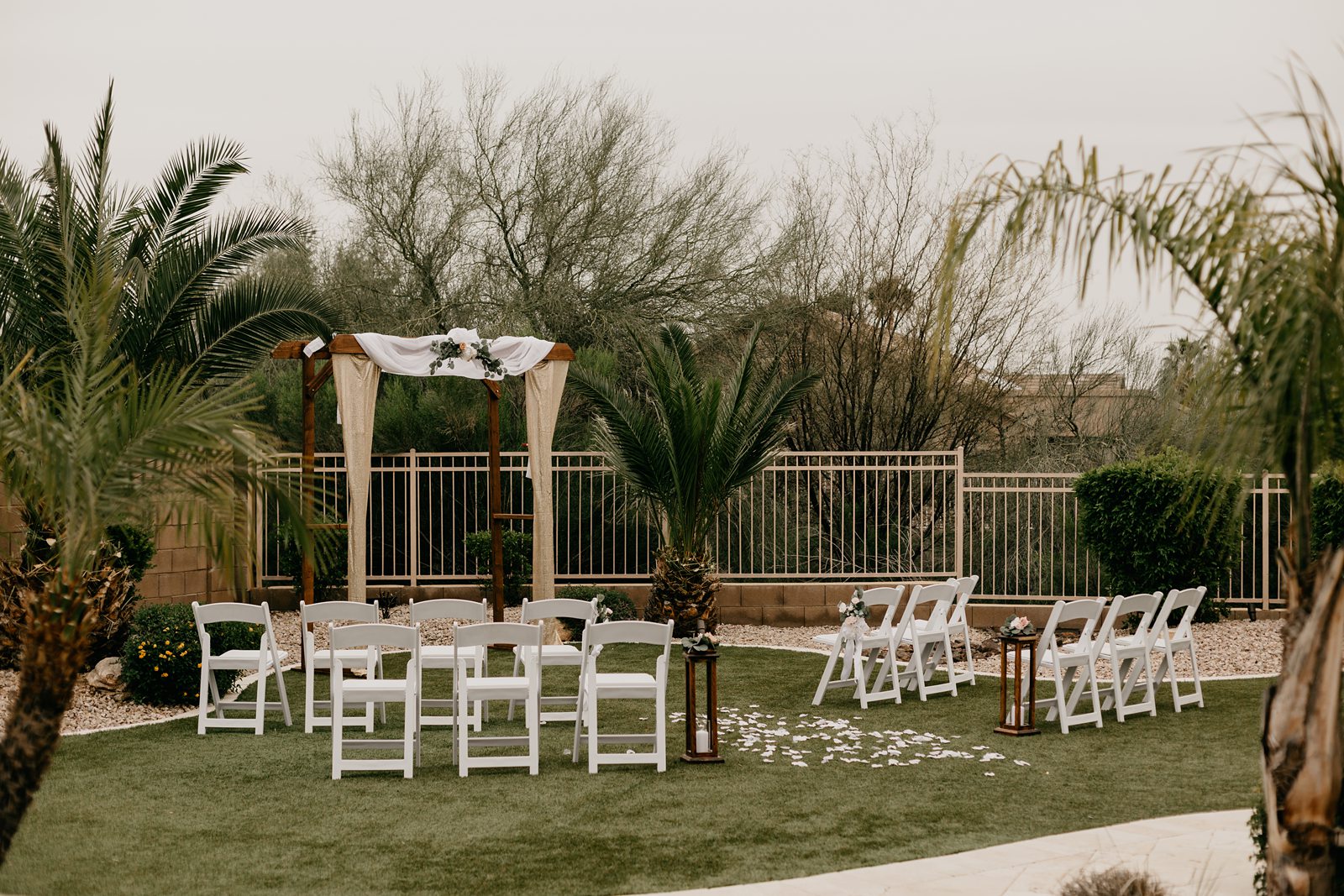 Ceremony setup with chairs and decorated arch for backyard elopement in Glendale AZ