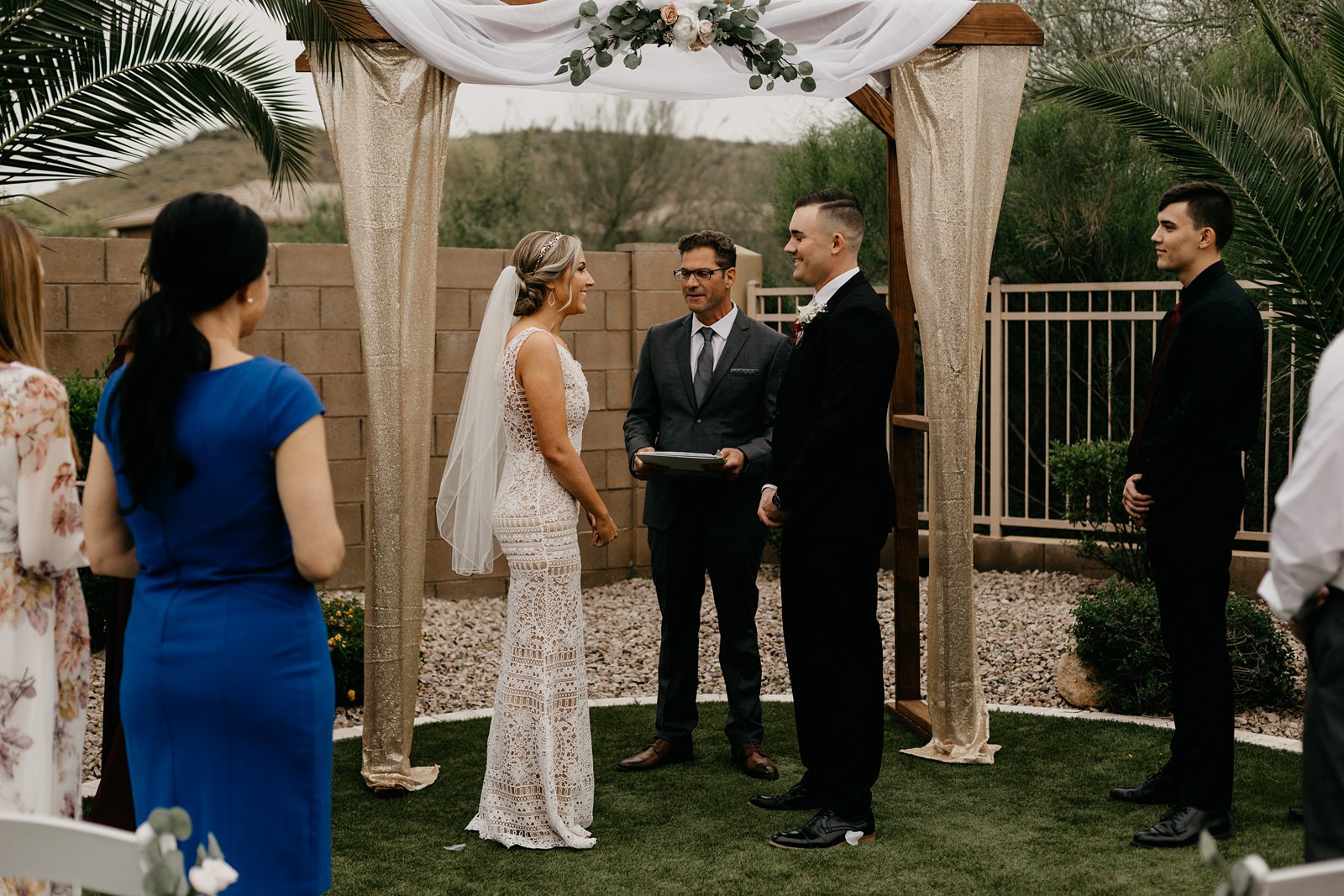 A bride and groom up at the altar for their ceremony during their backyard elopement in Glendale Az