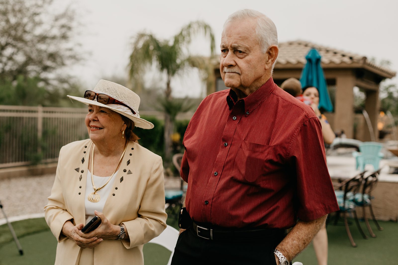 Grandparents watching an intimate wedding ceremony in a backyard in Phoenix