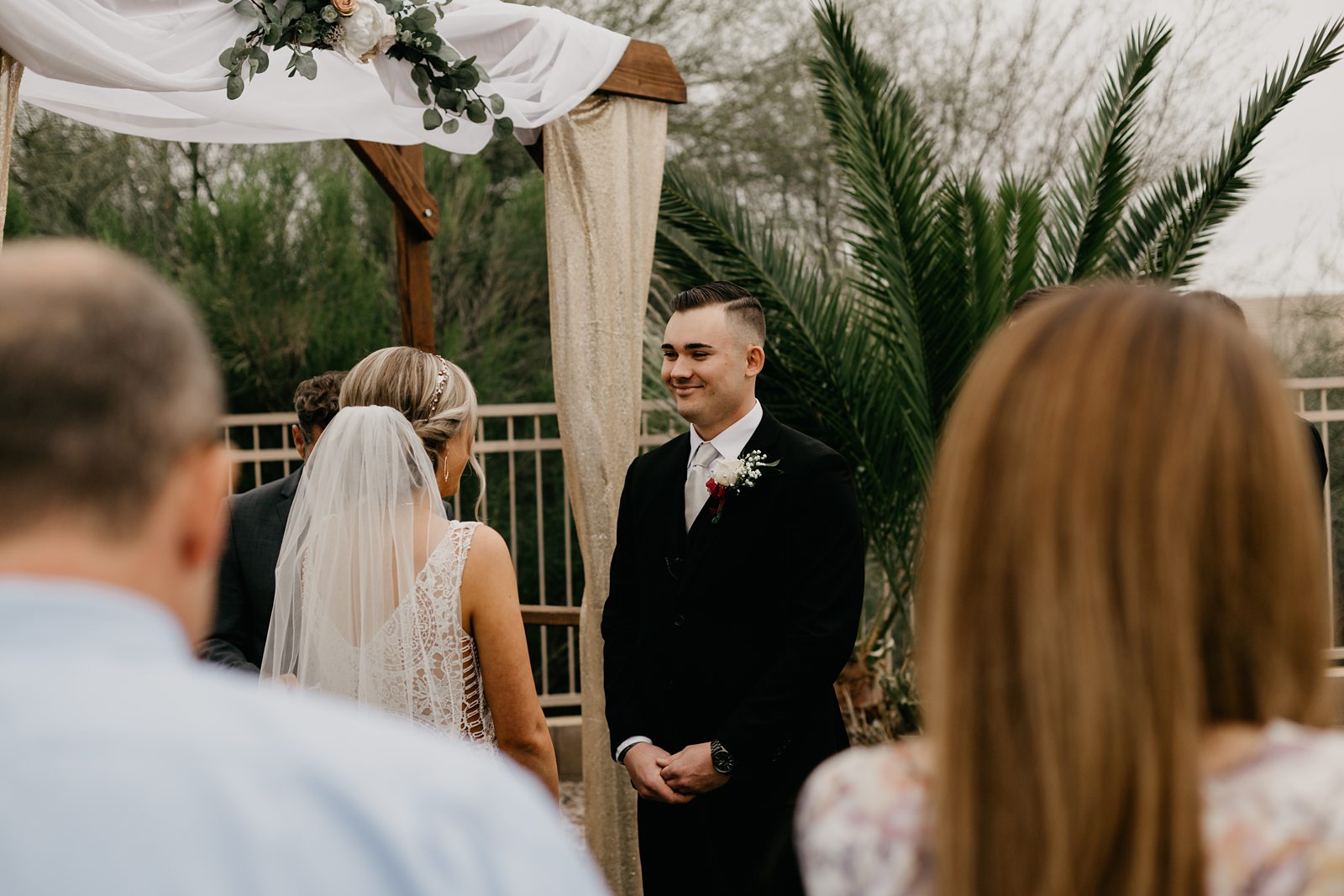 A bride and groom up at the altar for their ceremony during their backyard elopement in Glendale Az