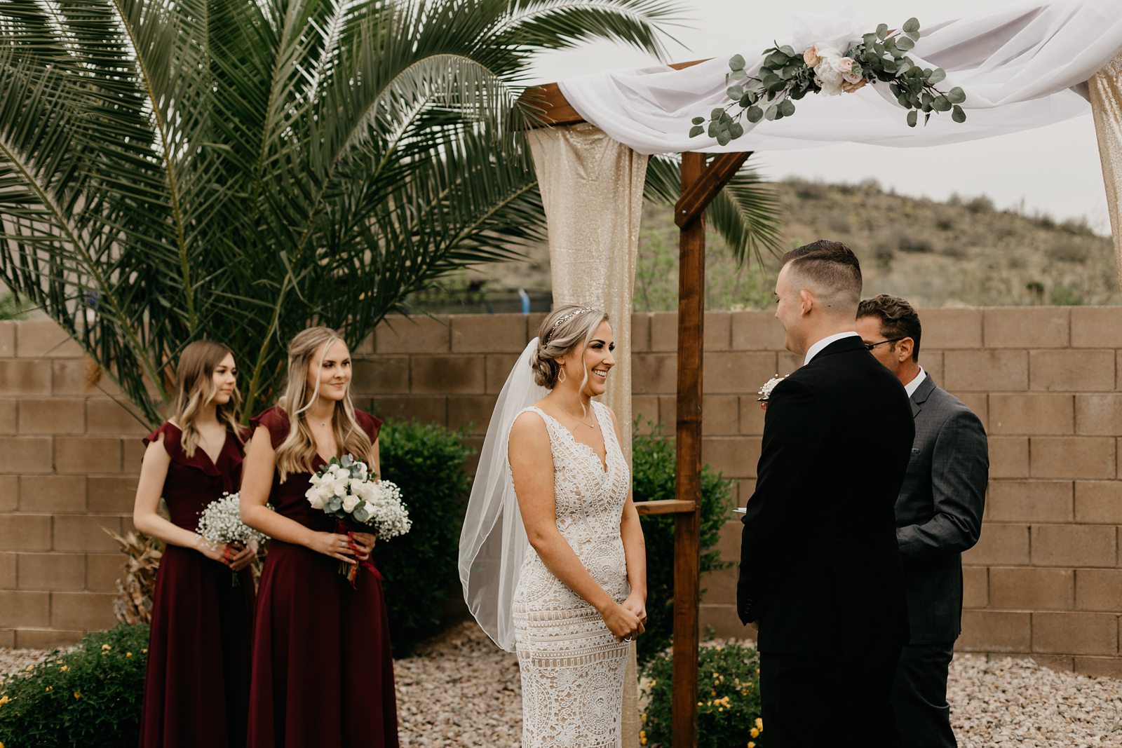 A bride and groom up at the altar for their ceremony during their backyard elopement in Glendale Az