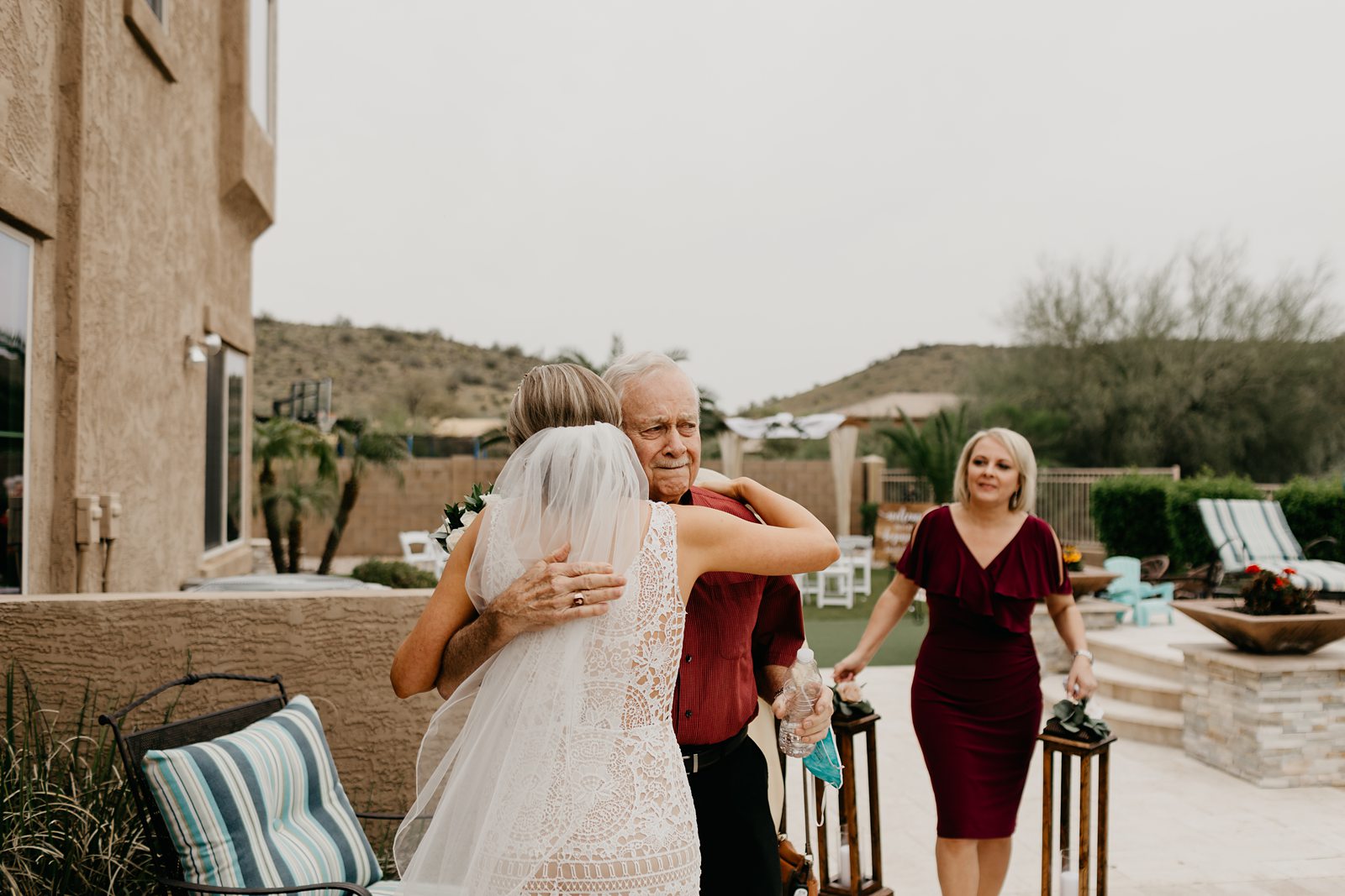 A happy bride hugging family after her wedding ceremony