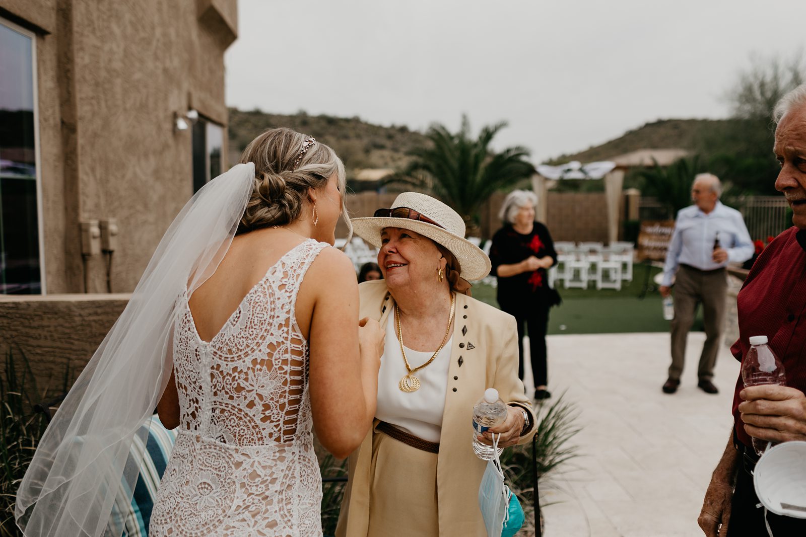 A happy bride hugging family after her wedding ceremony