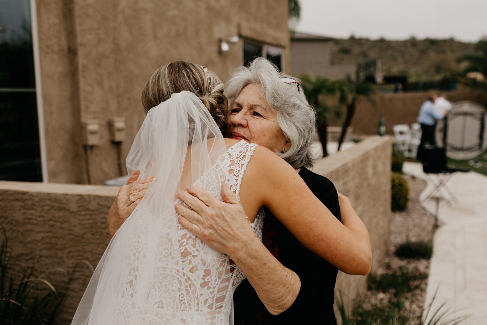 A happy bride hugging family after her wedding ceremony