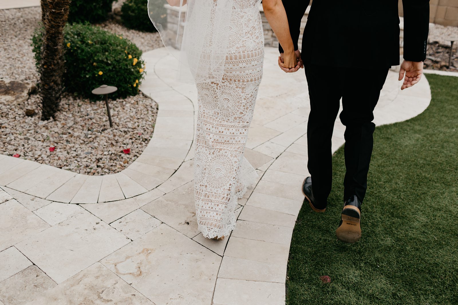 Portrait of briding groom's legs as they walk away through their backyard intimate wedding in Phoenix Arizona