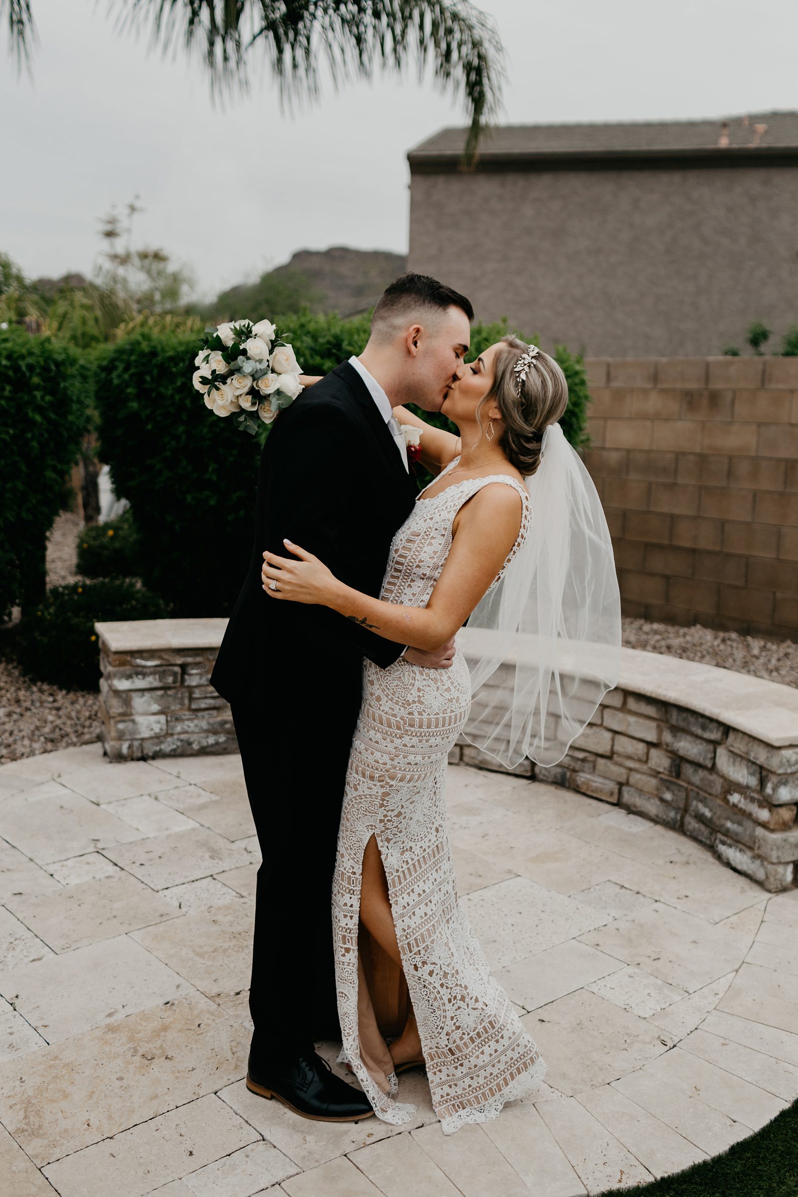 Portrait of bride and groom kissing in their backyard wedding Glendale az