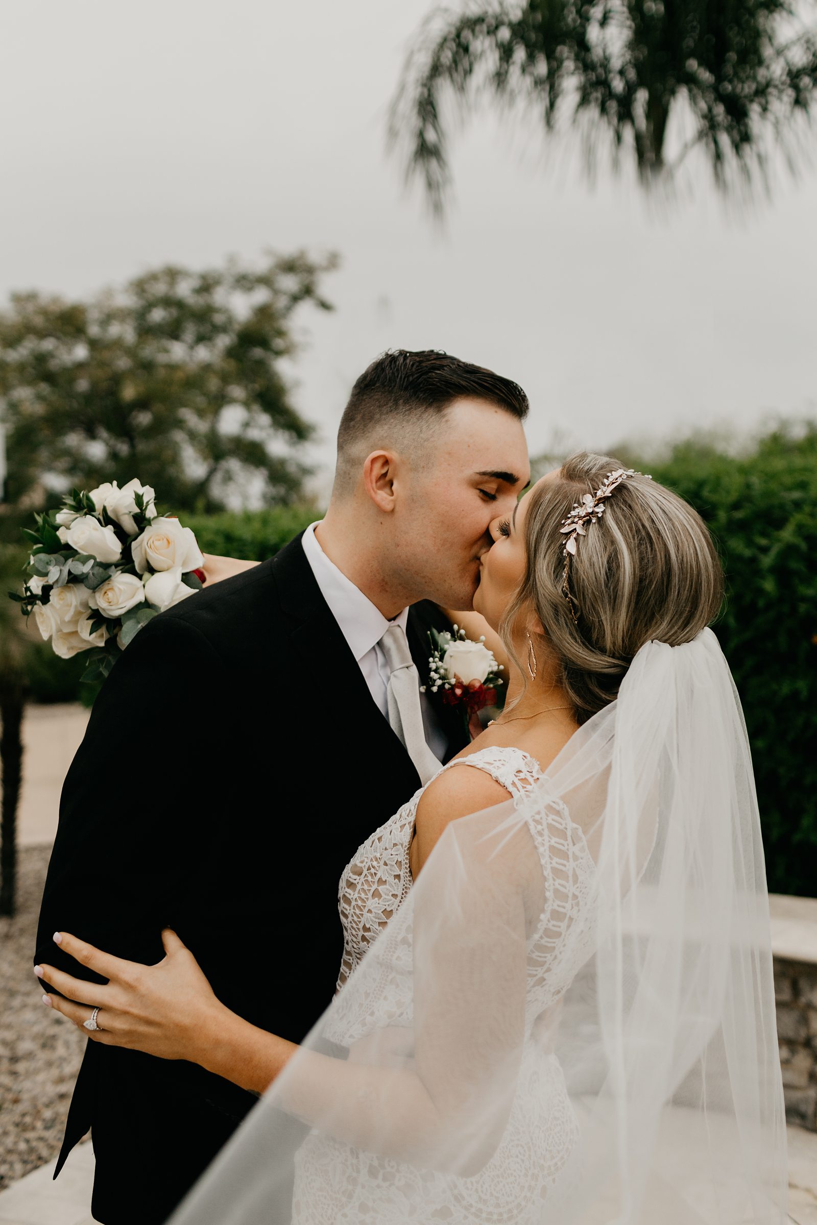 Portrait of bride and groom kissing in their backyard wedding Glendale az