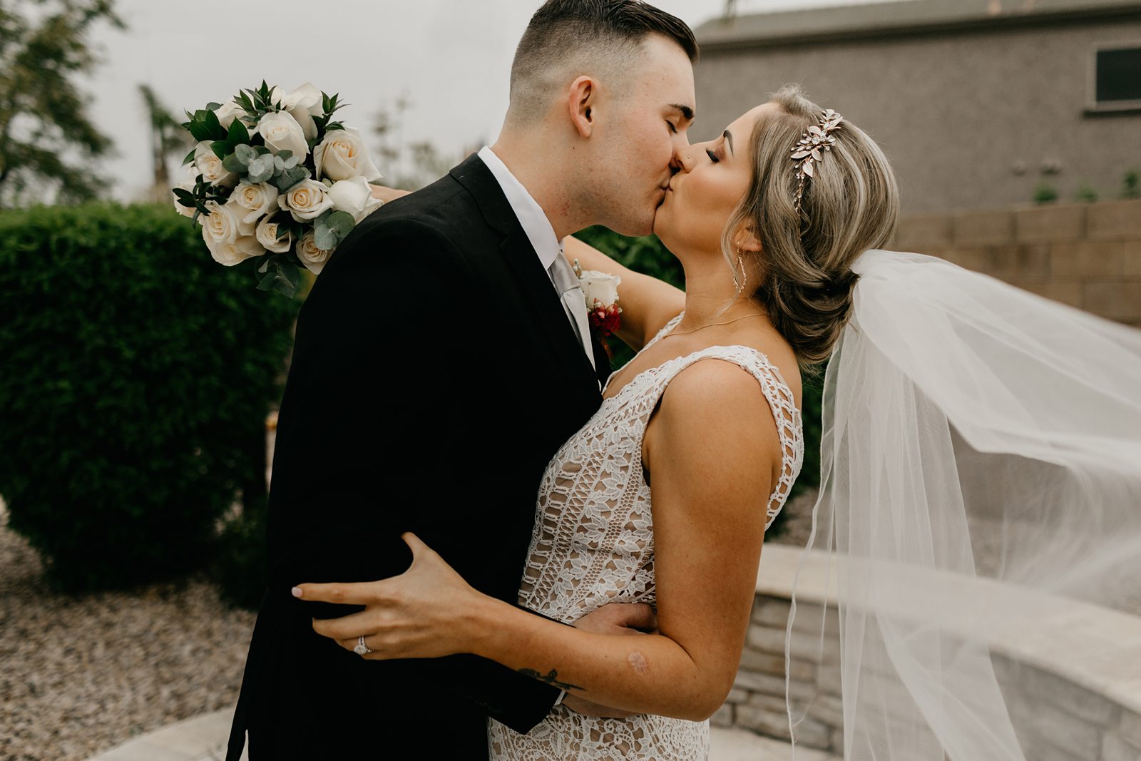 Portrait of bride and groom kissing in their backyard wedding Glendale az