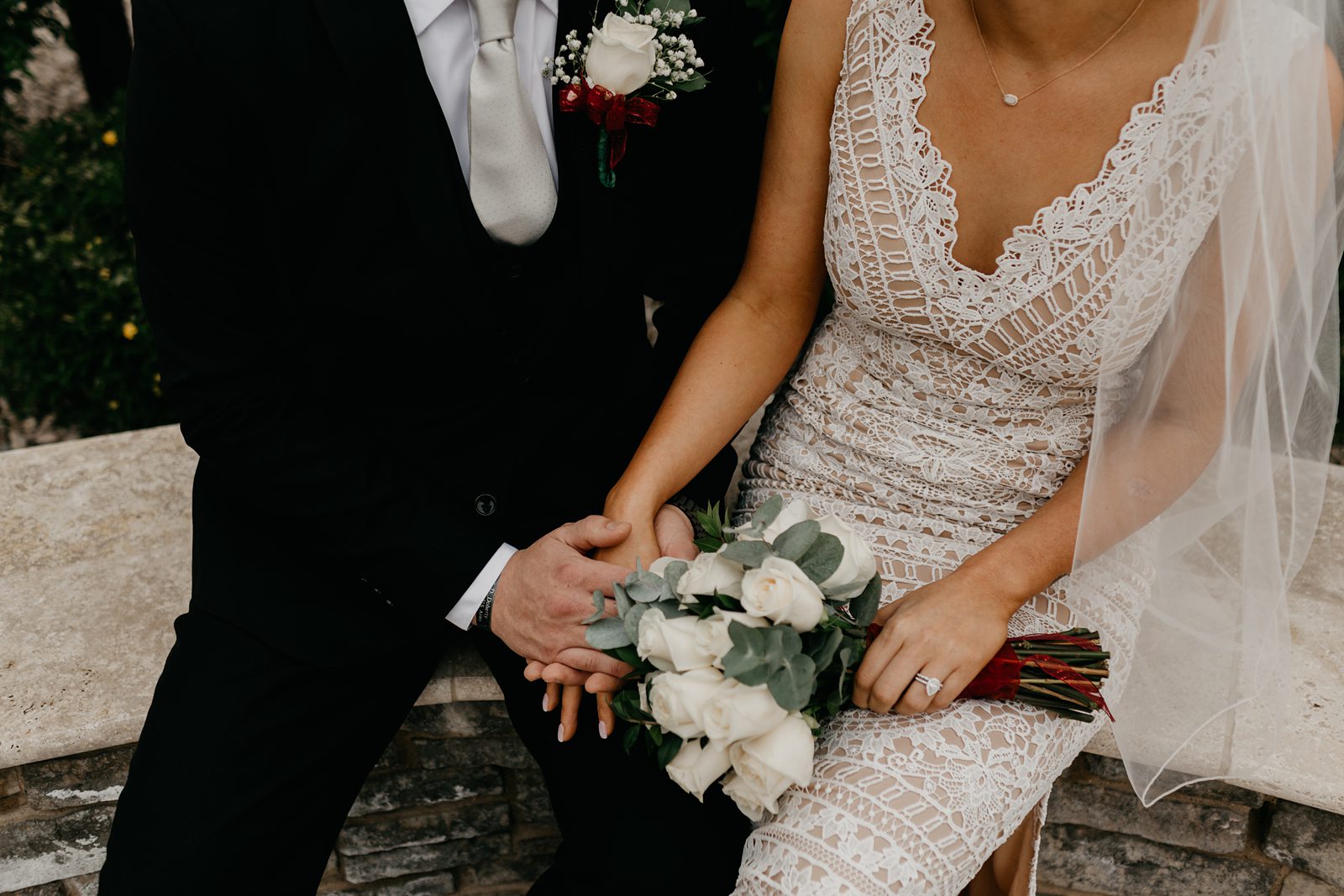 Wedding photo of bride and groom sitting holding hands in phoenix AZ