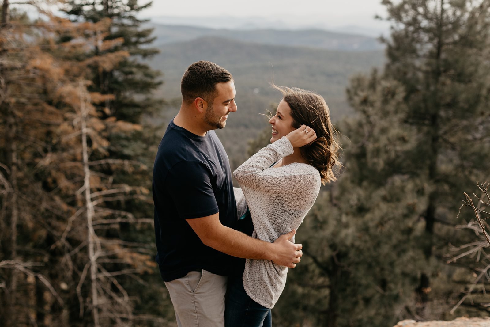 Mogollon Rim couple, hugging, laughing, Arizona pine tree engagement pictures