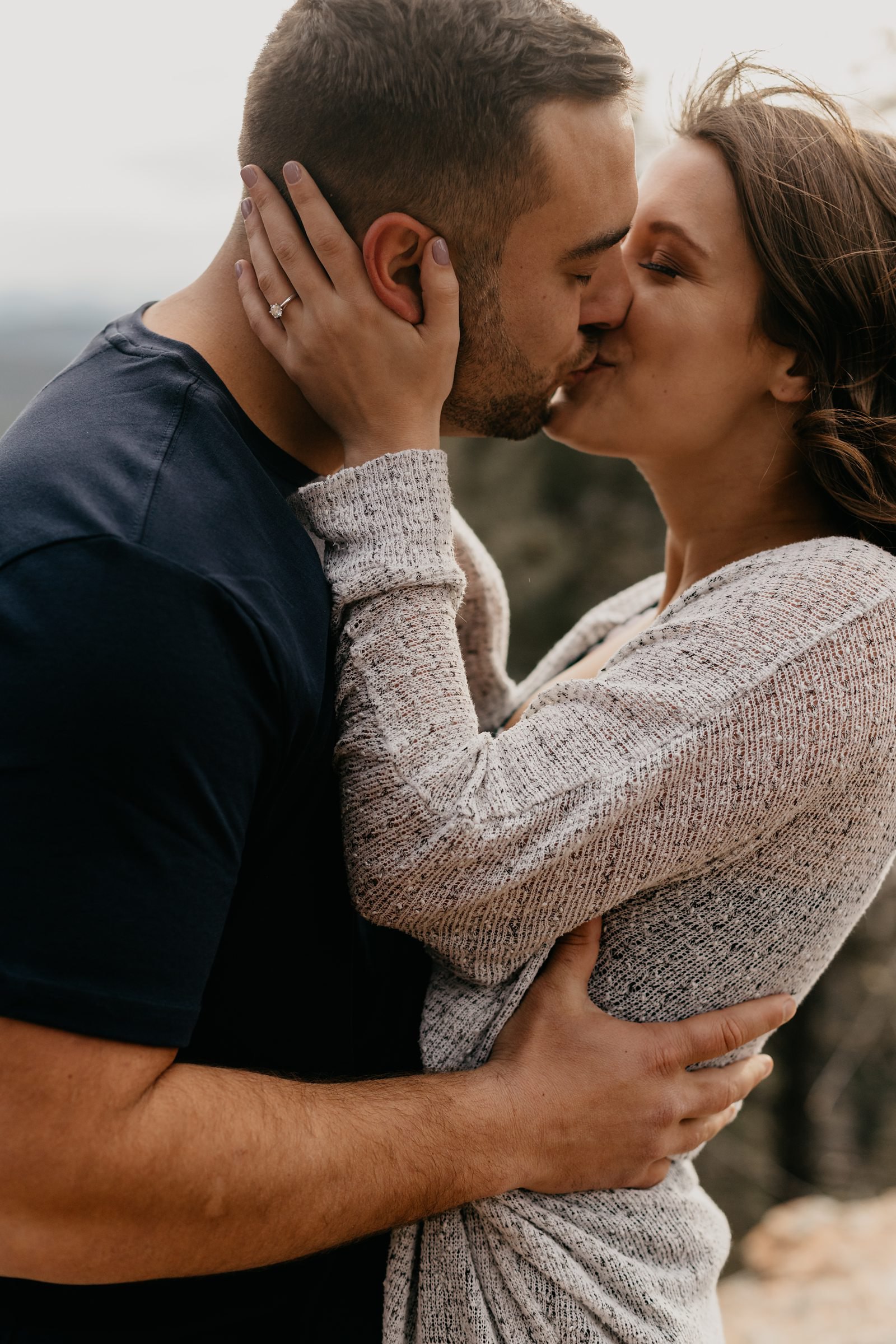 Arizona mountain top engagement, close-up photo of couple, hugging and kissing