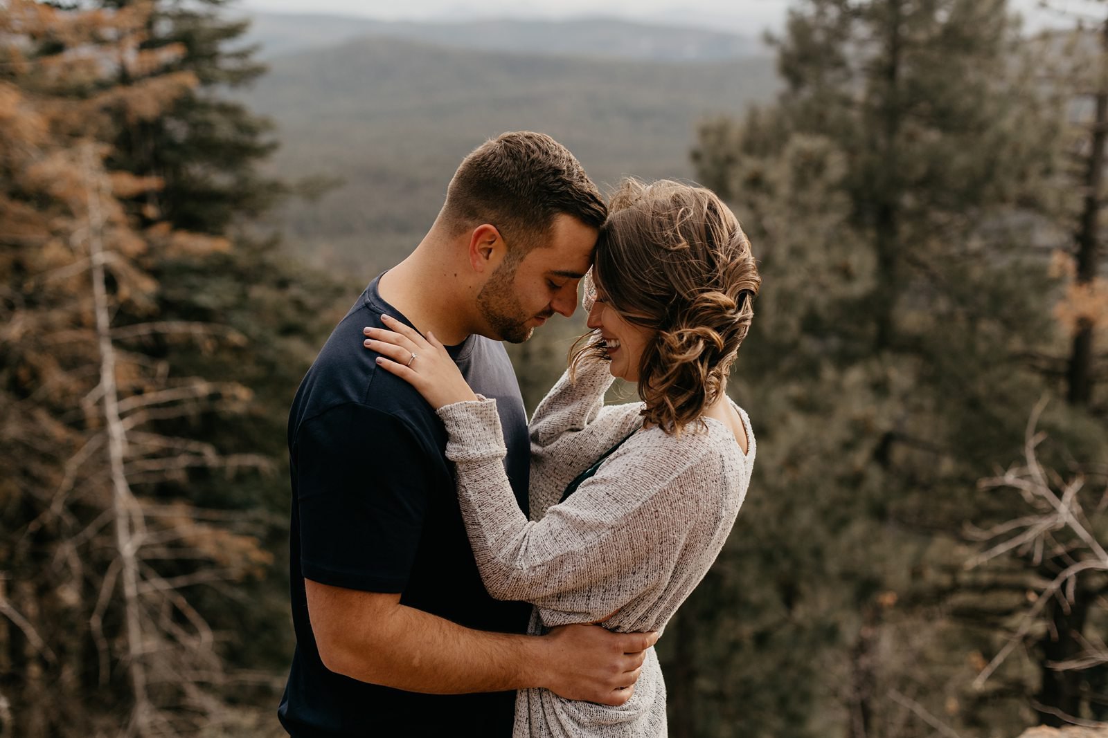 Payson Arizona mountain top engagement couple with their foreheads together