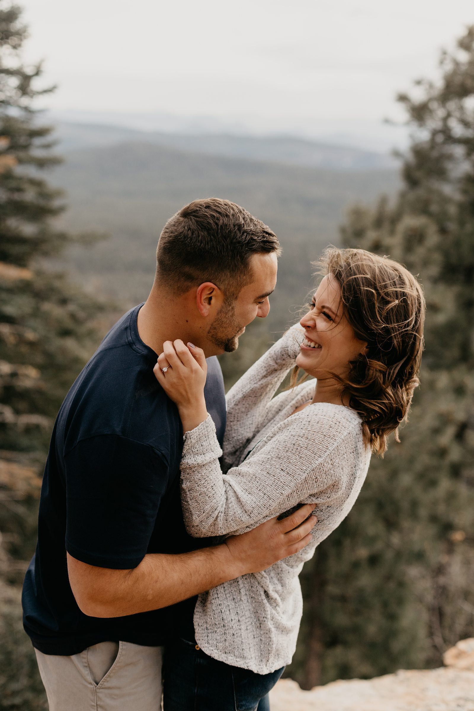 Mogollon Rim, engagement, photos, Payson, AZ, couple, hugging, and laughing on a mountaintop