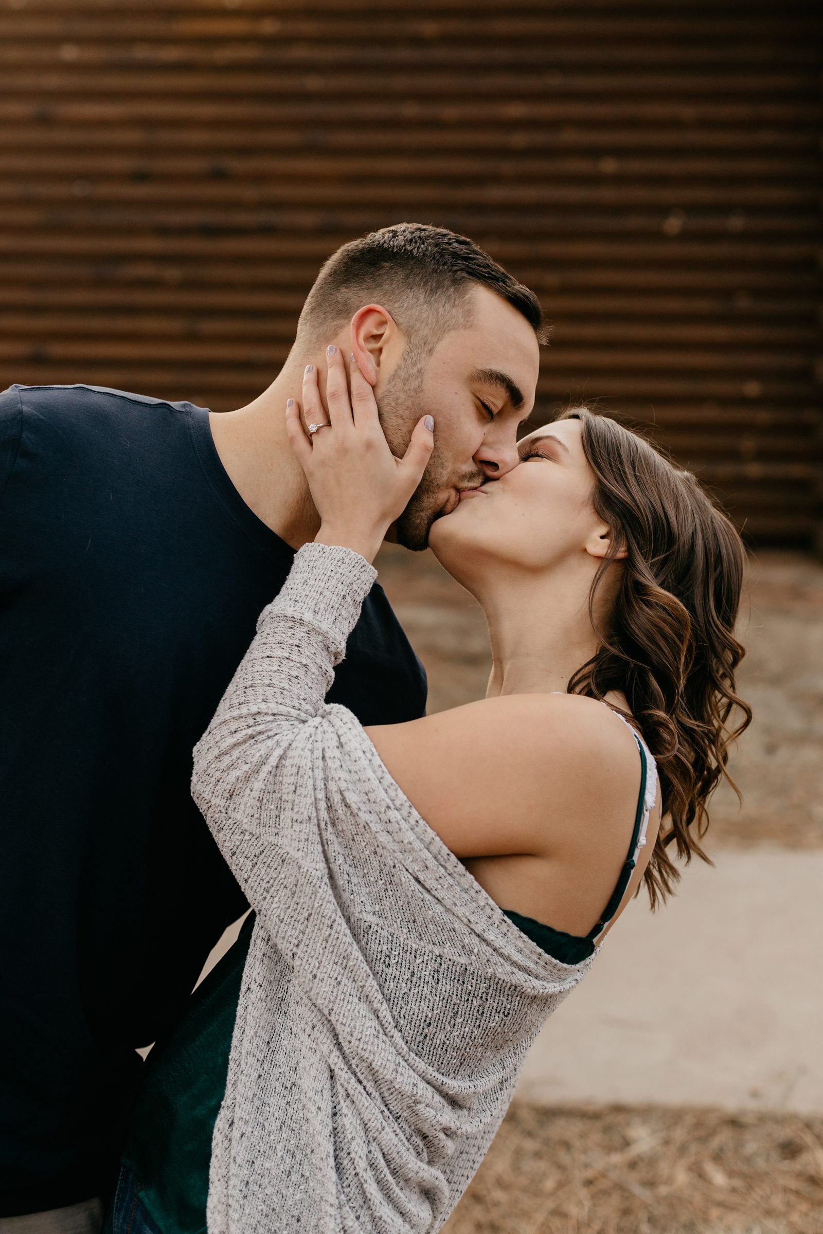 Payson, AZ couple kissing in front of cabin