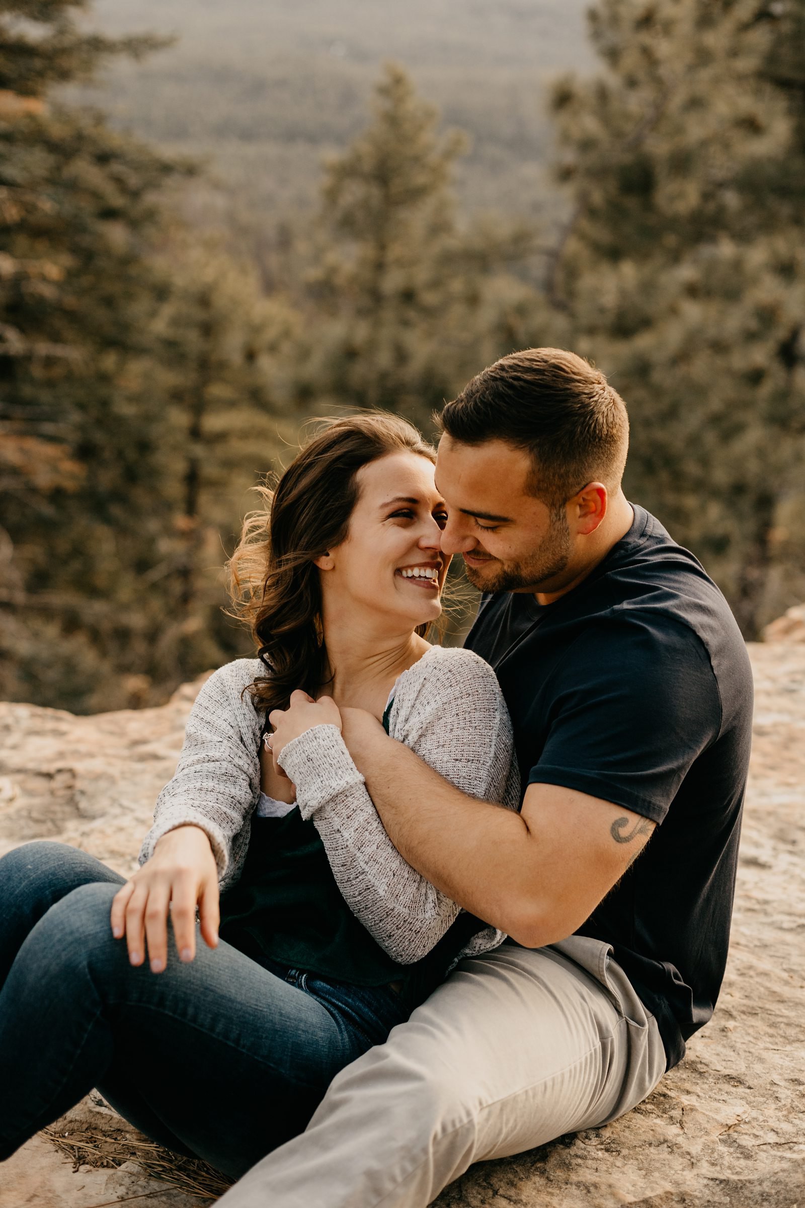 Couple sitting cuddled up on a mountain top in Arizona