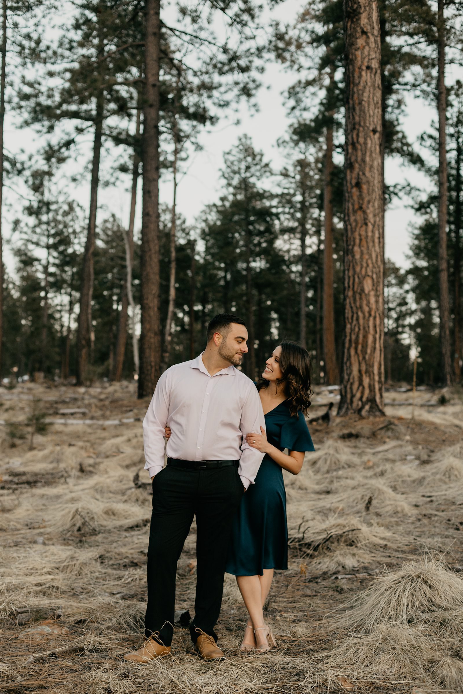 Arizona pine tree engagement pictures couple hugging with pine trees