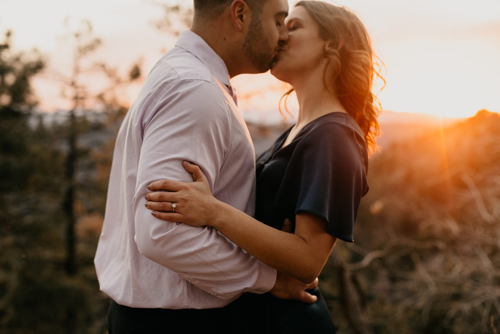 Sunset, orange glow couple, kissing engagement ring