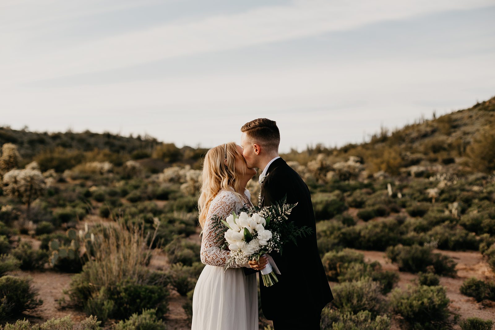 bride and groom kiss during their desert elopement photos in phoenix arizona