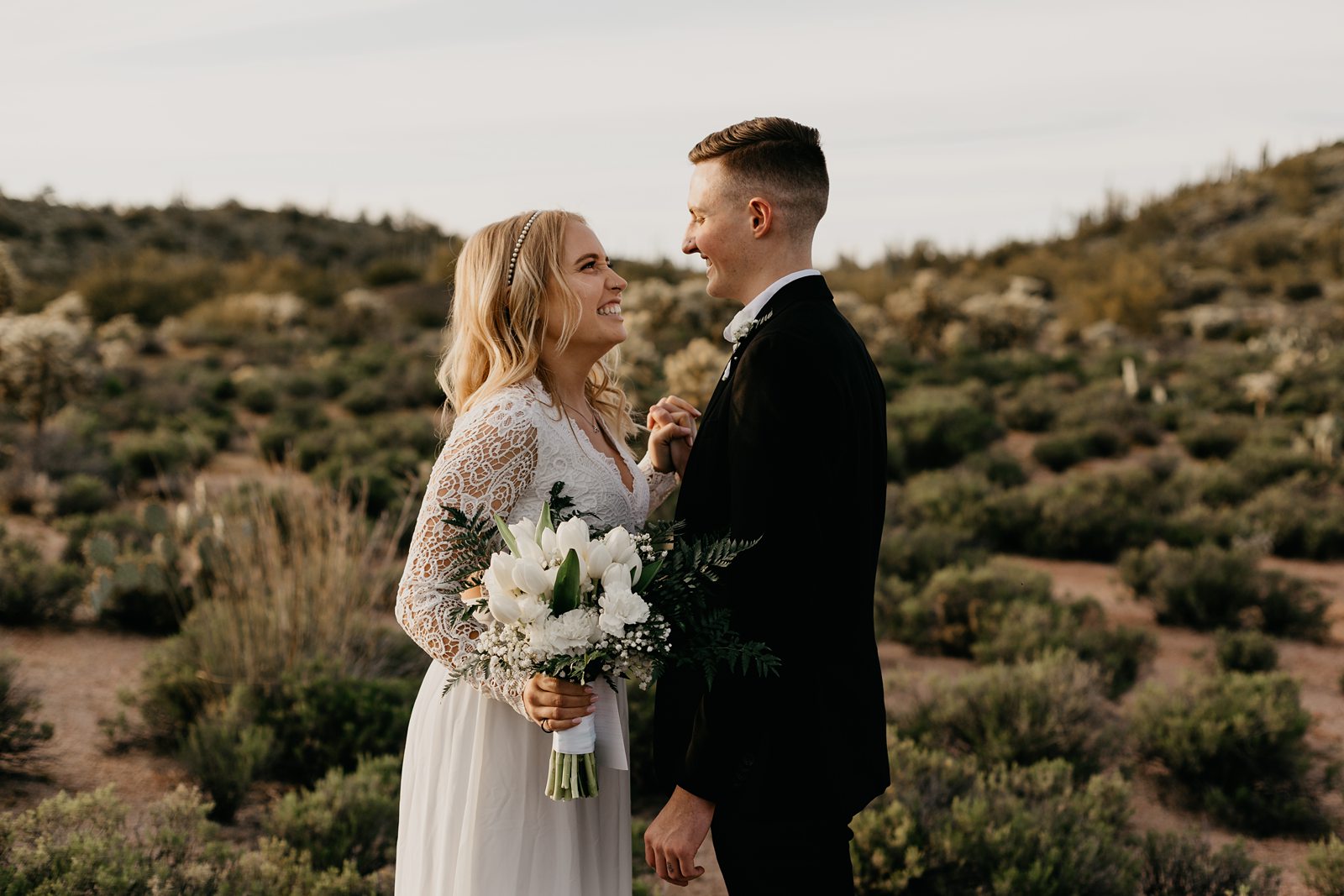 fun happy bride and groom frist look during their desert elopement photos in phoenix arizona