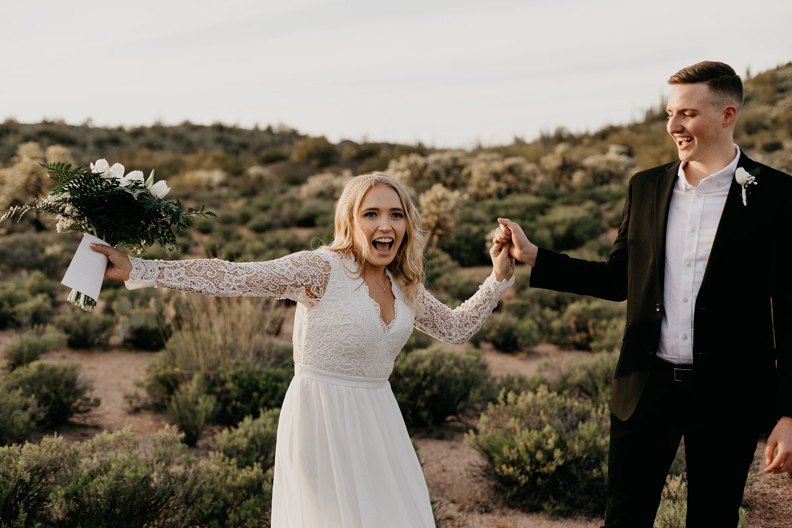 fun happy bride and groom frist look during their desert elopement photos in phoenix arizona