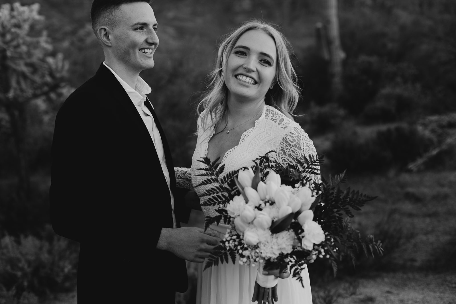 black and white photo of eloping couple laughing