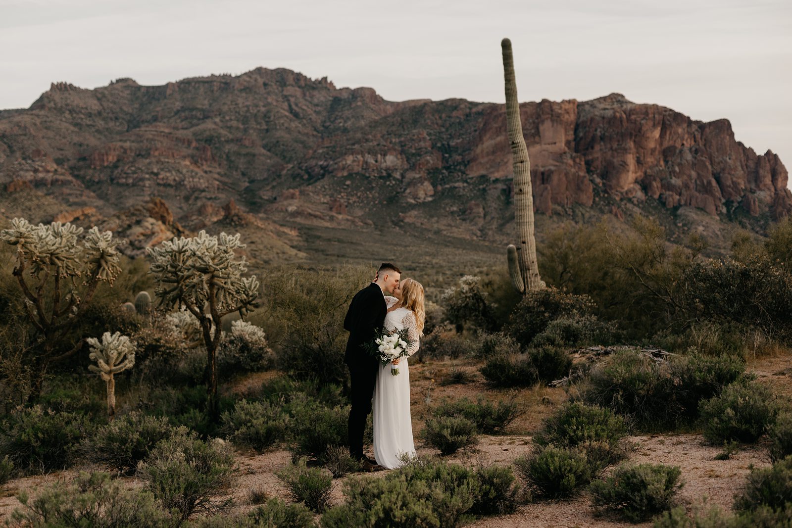 bride and groom kissing at their superstition mountain intimate elopement phoenix AZ