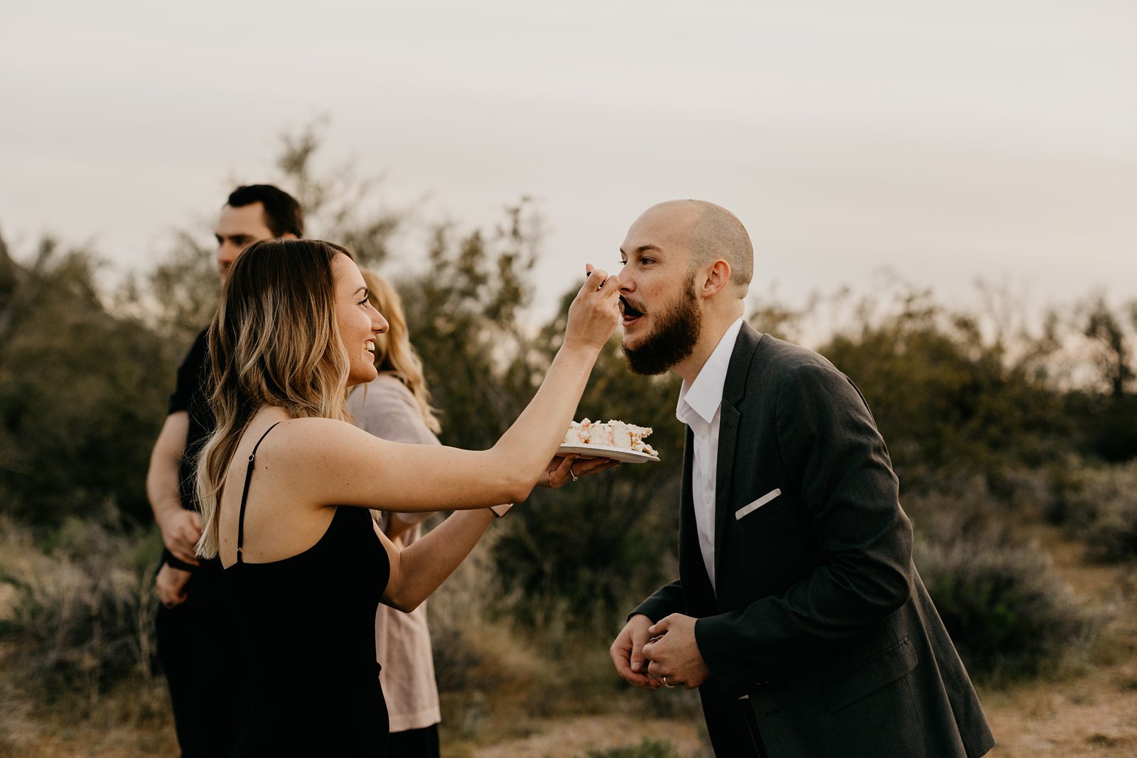 wedding guests cake cutting in the desert for superstition mountain intimate elopement phoenix arizona