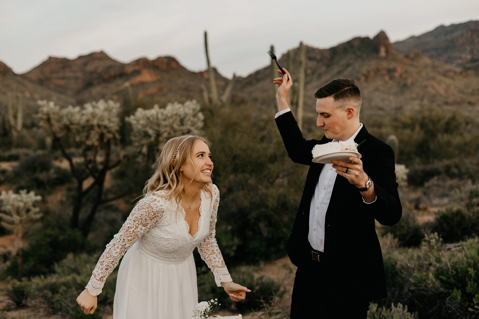 Wedding couple cake cutting in the desert for superstition mountain intimate elopement phoenix arizona