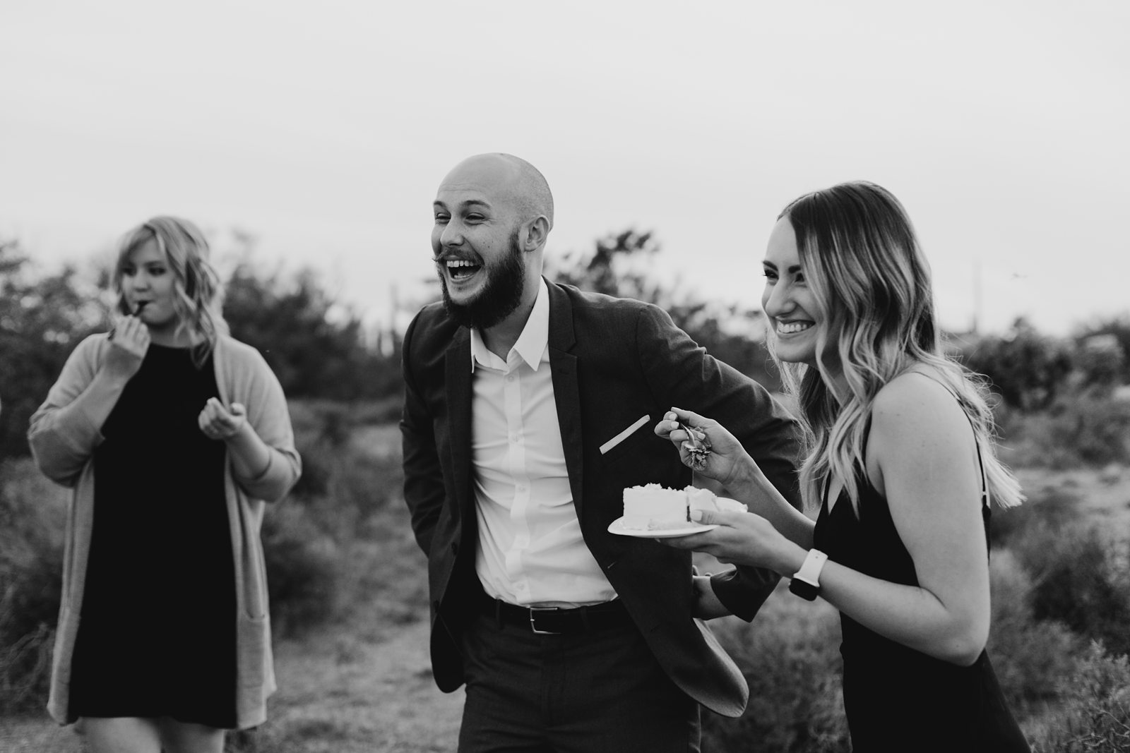 wedding guests laughing cake cutting in the desert for superstition mountain intimate elopement phoenix arizona