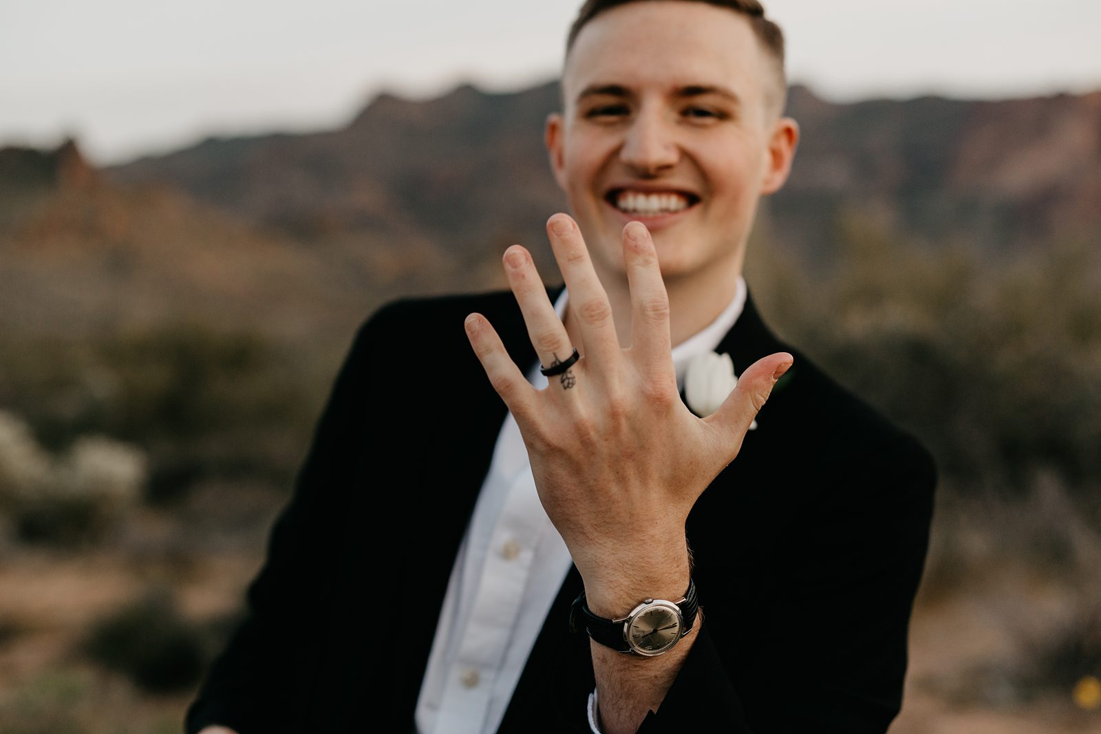 groom excitedly showing off his new wedding ring phoenix elopement photos