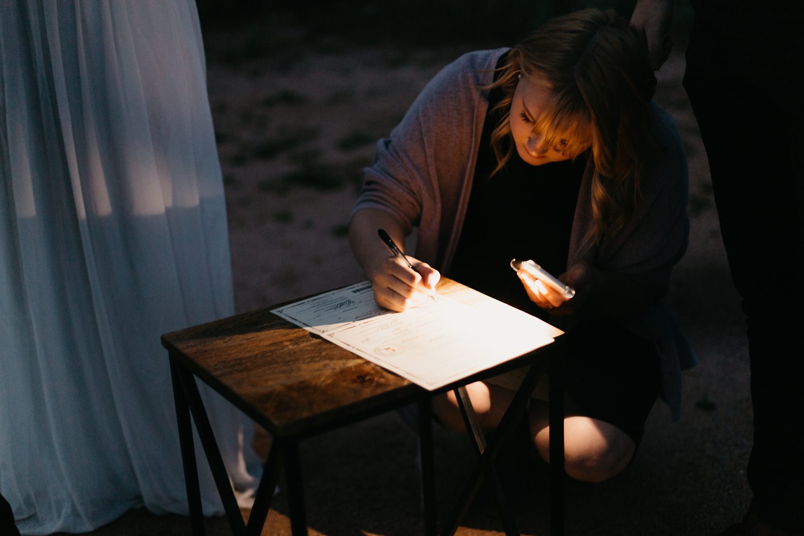 intimate wedding license signing by flashlight in the desert of arizona