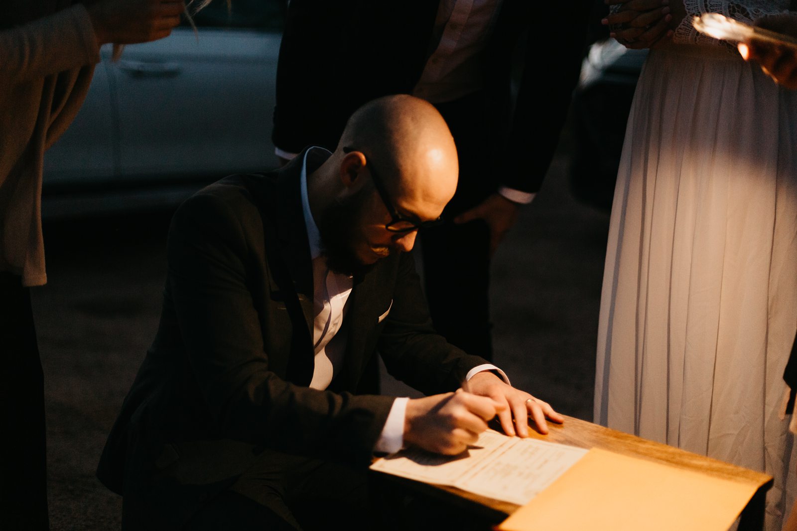 intimate wedding license signing by flashlight in the desert of arizona