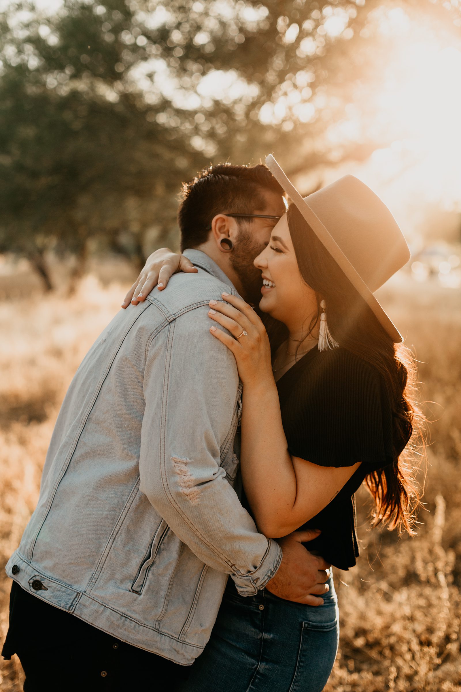 glowing sunset engagement photo of a couple in arizona with grass and trees in the background