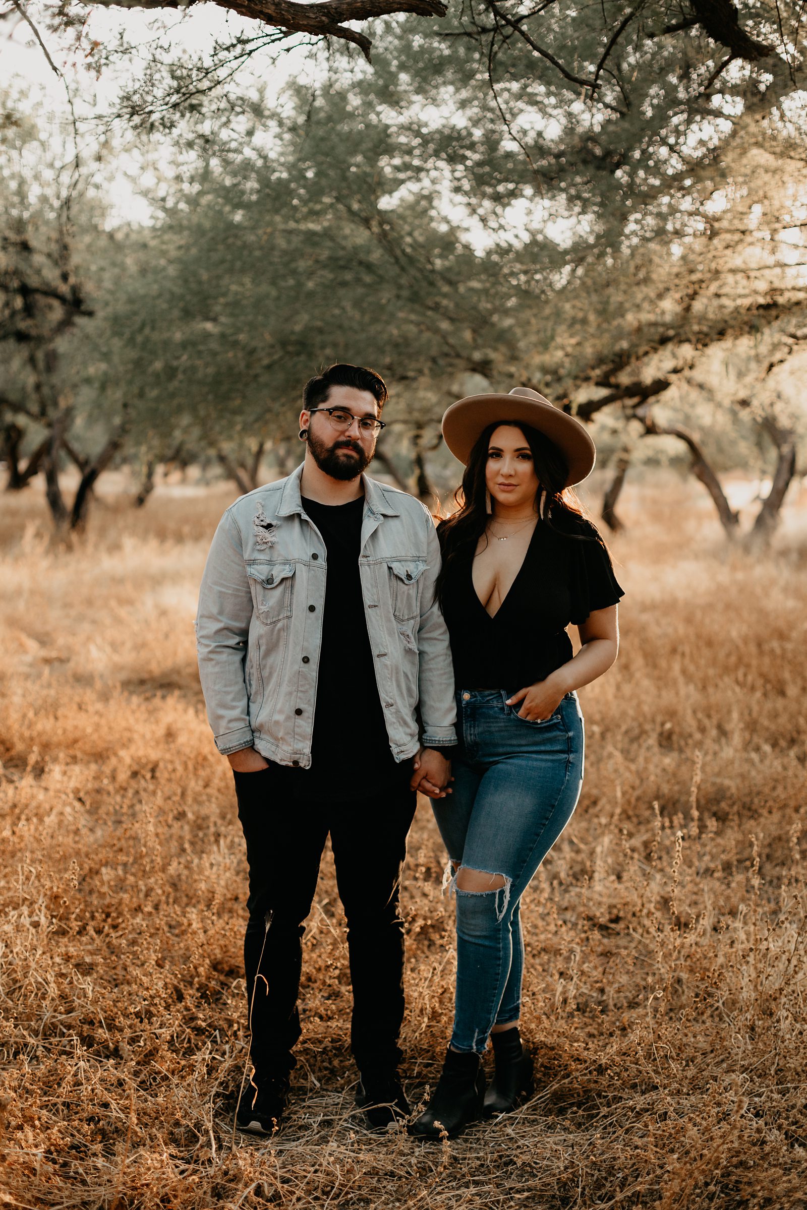 young couple's engagement photos around grass and trees at coon bluff in phoenix arizona