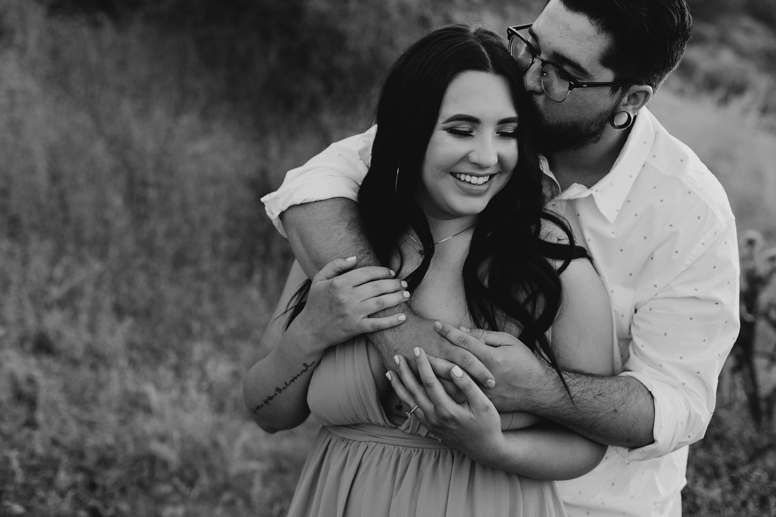 black and white couple cuddling engagement picture