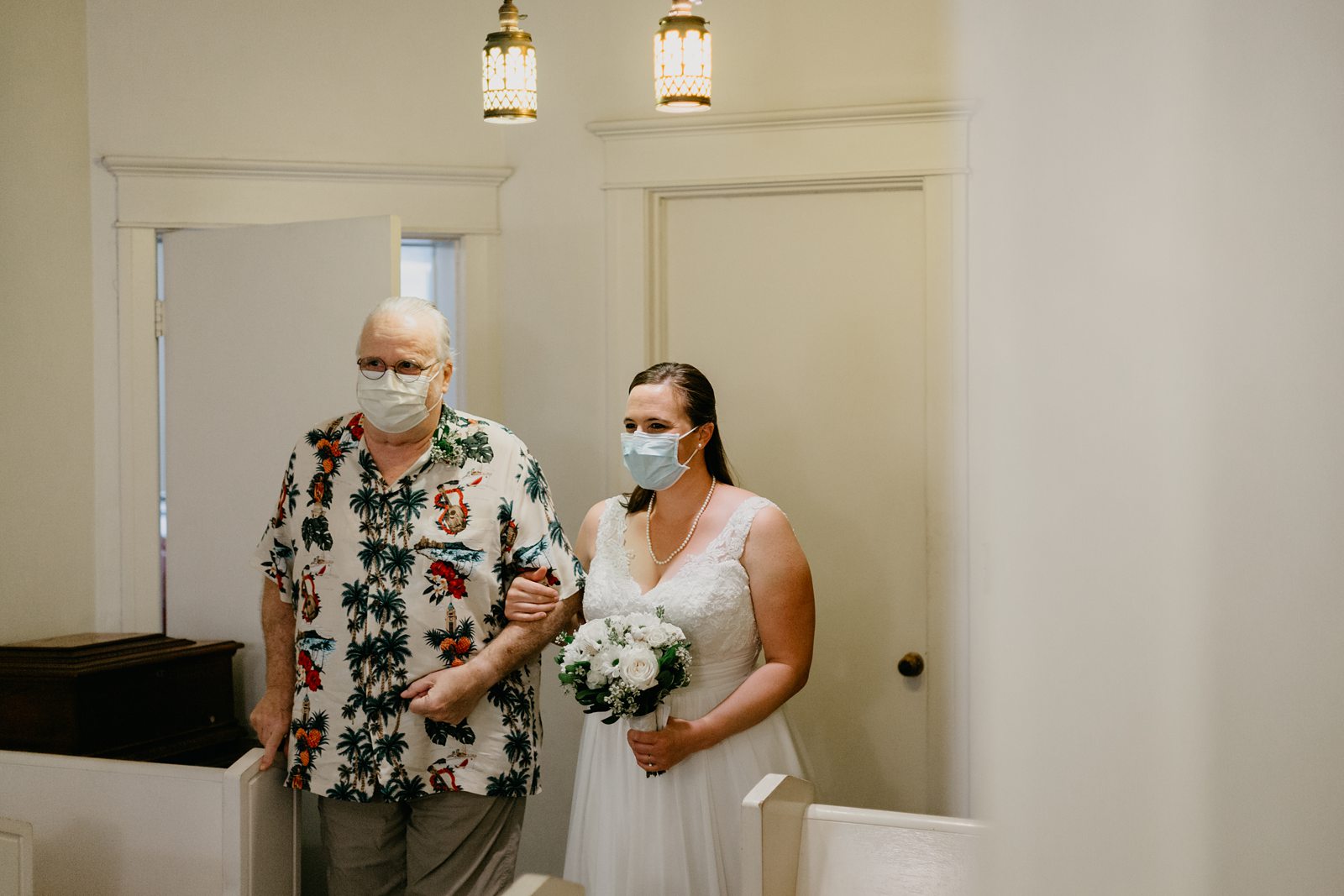 Lutes wedding chapel yuma elopement photos bride and father looking at each other about to walk down the aisle in face masks