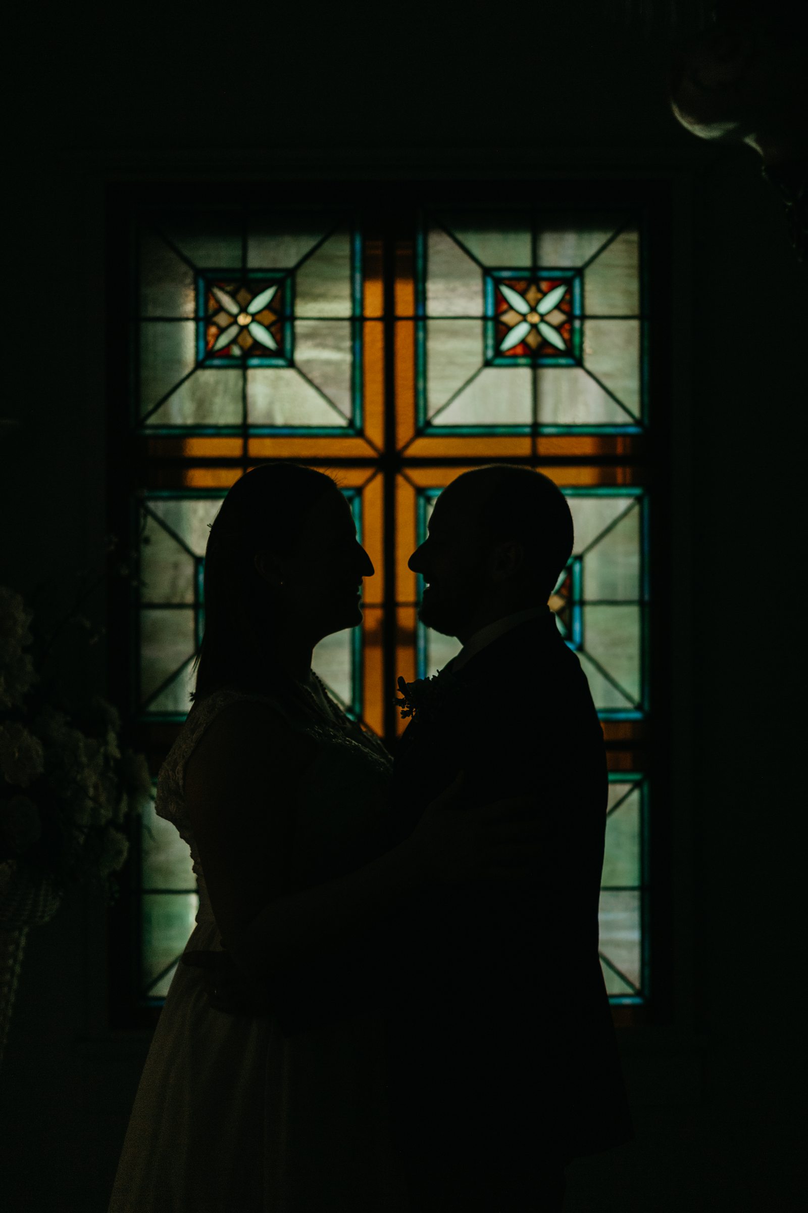 Stained glass silhouette yuma elopement photos in arizona at Lutes wedding chapel