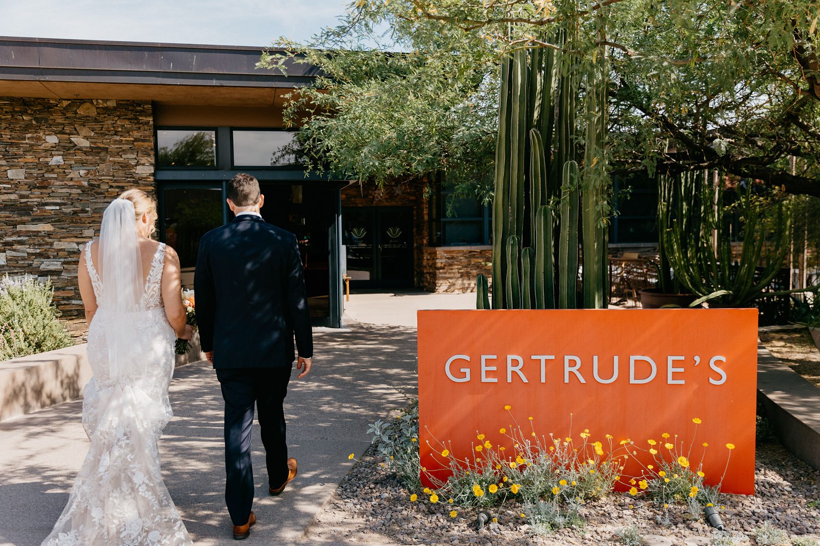 Eloping couple walking into their reception restaurant 