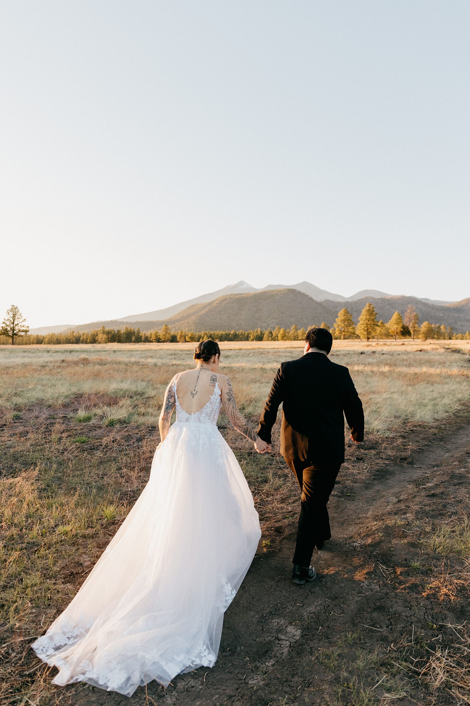 Flagstaff field elopement, couple walking away from camera