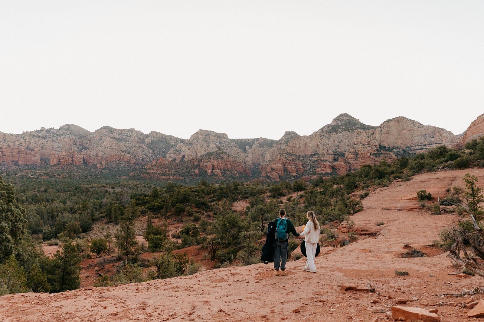 Eloping couple hiking to their ceremony spot in Sedona AZ